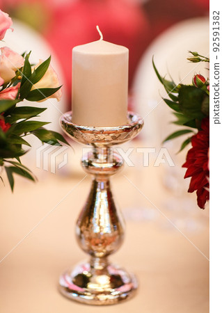 Candle on the white table Candle on the white table 92591382