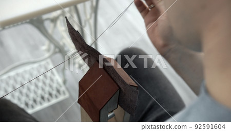 Sewing a brown leather wallet. Leather work. Sewing products by hand. Manufacture of leather goods. 92591604