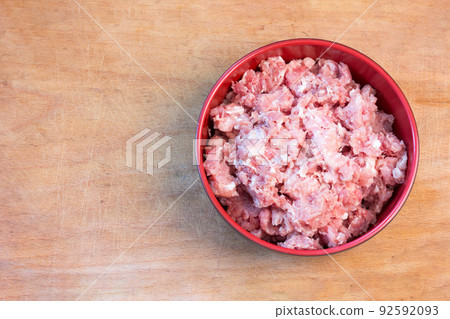 Fresh raw minced meat on a cutting board, top view close-up 92592093