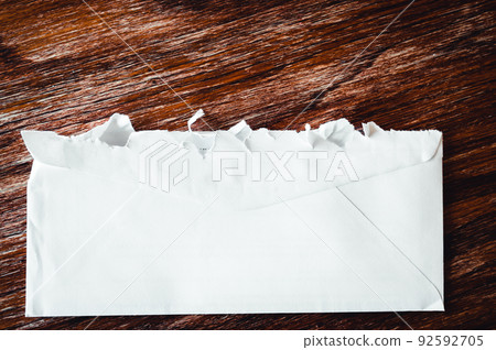Selective focus on jagged edges of a ripped open mail envelope Selective focus on jagged edges of a ripped open mail envelope 92592705