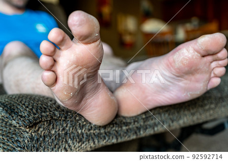 white Caucasian male with feet elevated on reclining chair white Caucasian male with feet elevated on reclining chair 92592714