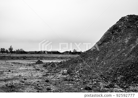 stockpiled topsoil at a residential development construction site. 92592777