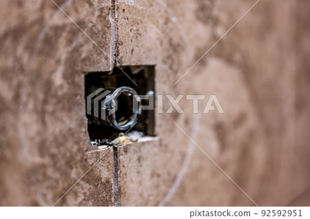 Cut-out section in bathroom shower tile with pipe connection protruding for water hookup. Cut-out section in bathroom shower tile with pipe connection protruding for water hookup. 92592951