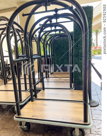 Group of hotel luggage carts at the entrance for guests checking in. 92592988