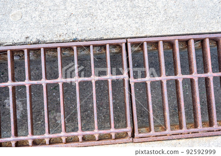 Grate over a stormwater trench in a concrete slab. Grate over a stormwater trench in a concrete slab. 92592999