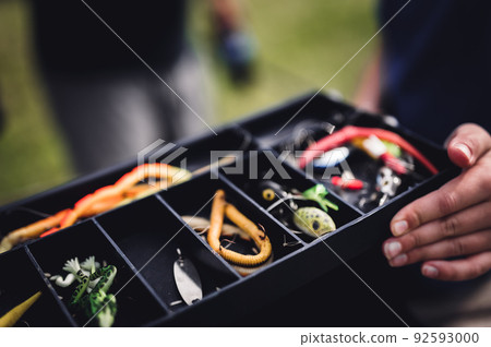 Selective focus on lure inside an open fishing tackle box.  92593000