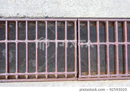 Grate over a stormwater trench in a concrete slab.  92593020