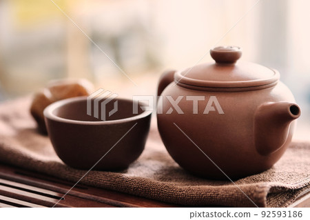 Chinese brown clay teapot and cup Chinese brown clay teapot and cup 92593186