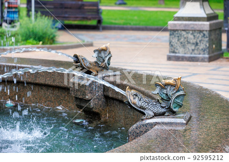 Elements of a beautiful graceful city fountain in the form of fish. 92595212