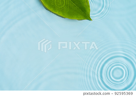 Blue water texture, blue mint water surface with rings and ripples. Spa concept background. Flat lay, copy space. Blue water texture, blue mint water surface with rings and ripples. Spa concept background. Flat lay, copy space. 92595369
