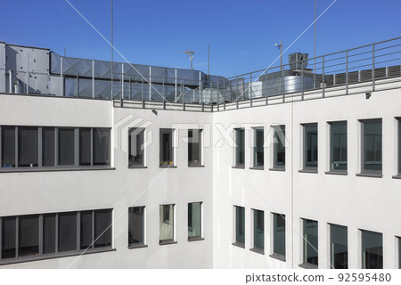 An office building with rooftop air conditioning system. 92595480