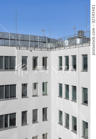 An office building with rooftop air conditioning system. 92595481