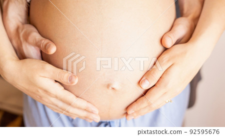 Pregnant hands woman belly. Happy pregnancy woman and husband hugging pregnant belly. Concept maternity, pregnancy, childbirth. 92595676