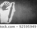 Baking dark background with outlines of ingredient flour of rolling pin and imprint of human hand top view with copy space. 92595949