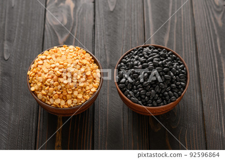Fresh organic natural beans and peas on wooden rustic black background Fresh organic natural beans and peas on wooden rustic black background 92596864