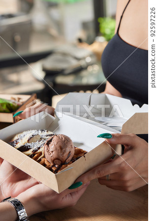 Delicious breakfast in the summer cafe. a dessert of Viennese waffles with a scoop of ice cream. 92597226