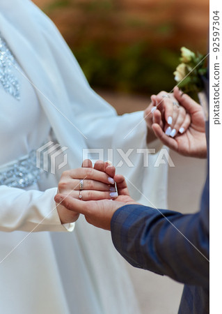 Bride and groom Asian Muslims marry in a beautiful red love theme. celebration nikah day. Bride and groom Asian Muslims marry in a beautiful red love theme. celebration nikah day. 92597304