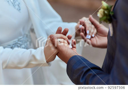 Bride and groom Asian Muslims marry in a beautiful red love theme. celebration nikah day. Bride and groom Asian Muslims marry in a beautiful red love theme. celebration nikah day. 92597306