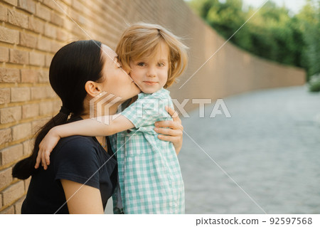 Beautiful mother kiss her cute little boy 92597568