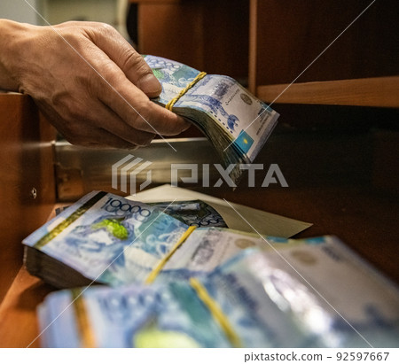 Thick wad of money cash on table. High quality photo Thick wad of money cash on table. High quality photo 92597667