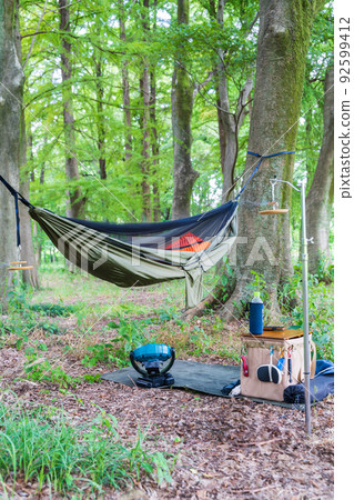 Hanging a hammock in a wooded area 92599412