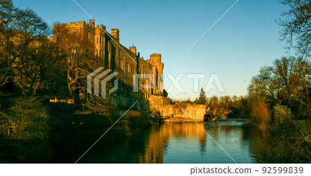 Ancient European medieval architectural building castle in golden autumn light with the blue sky background during autumn Ancient European medieval architectural building castle in golden autumn light with the blue sky background during autumn 92599839