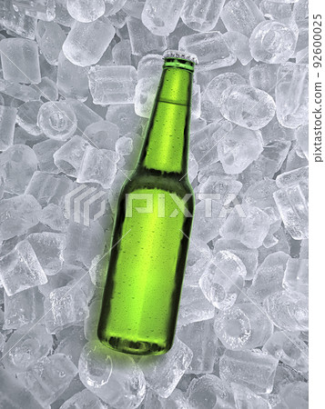 Beer bottle with water drops of cold beverage, ice cube a of juicy. Summer refreshing drink Beer bottle with water drops of cold beverage, ice cube a of juicy. Summer refreshing drink 92600025