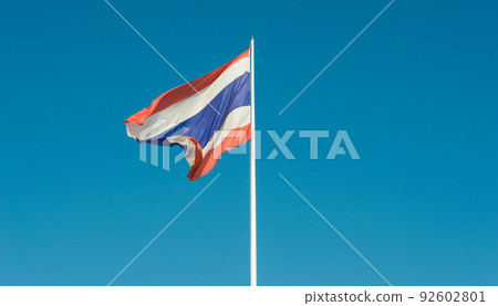Image of waving Thailand flag with clear blue sky. Thailand's flag stands for nation-religion-king, a kind of unofficial motto that Thai people live by. 92602801