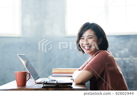 Female telework remote work smile looking at the camera Female telework remote work smile looking at the camera 92602944