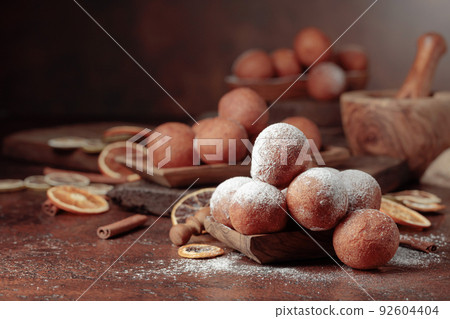 Cottage cheese doughnuts sprinkled with sugar powder. Cottage cheese doughnuts sprinkled with sugar powder. 92604404