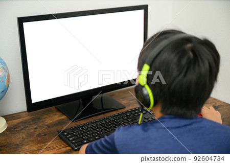 A boy who uses a computer for online lessons for synthesis A boy who uses a computer for online lessons for synthesis 92604784
