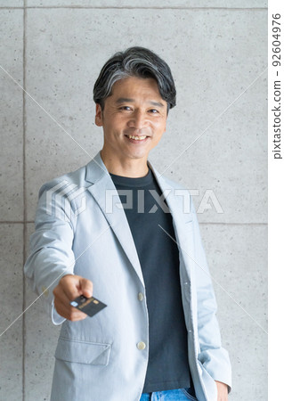 Middle man showing a card 92604976