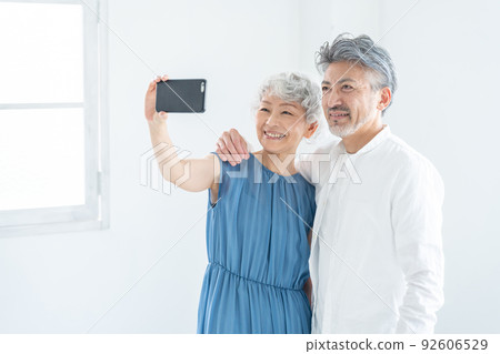 A senior couple who takes self-taking with a smartphone A senior couple who takes self-taking with a smartphone 92606529