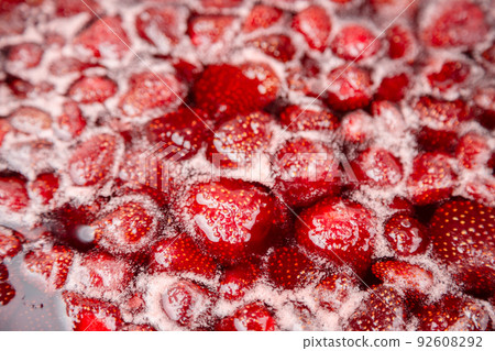 Cooking strawberry jam close up. 92608292