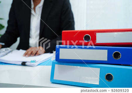 Stack of binder file folder on table in business modern office..on wooden desk in large modern office 92609320