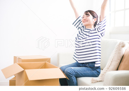 A woman taking a break during moving work 92609386