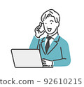 A man calling while looking at a personal computer 92610215