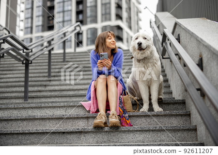 Woman with her dog at modern residential area 92611207
