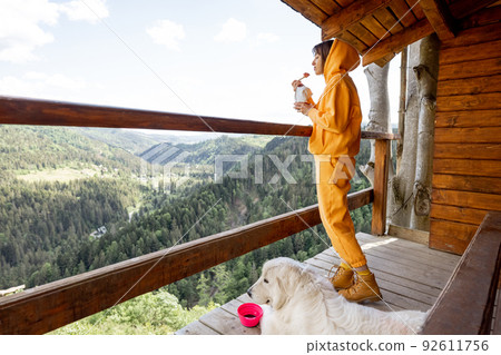 Woman eats freeze-dried food for hiking while traveling in mountains Woman eats freeze-dried food for hiking while traveling in mountains 92611756