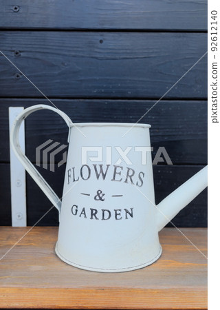 White watering can with text for gardening White watering can with text for gardening 92612140