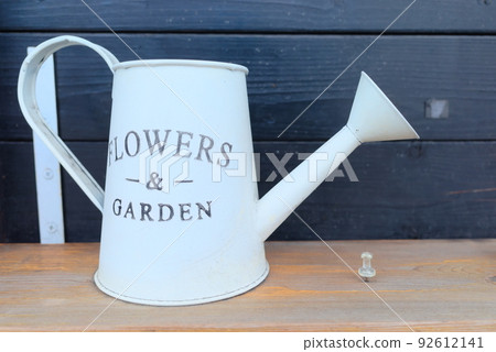White watering can with text for gardening White watering can with text for gardening 92612141