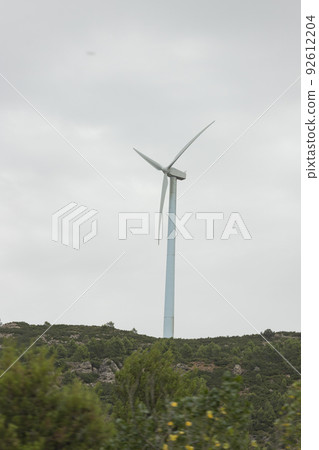 Wind turbines. Windmill in motion generating clean and renewable energy on a cloudy day, in Spain. Europe. Photography. Wind turbines. Windmill in motion generating clean and renewable energy on a cloudy day, in Spain. Europe. Photography. 92612204