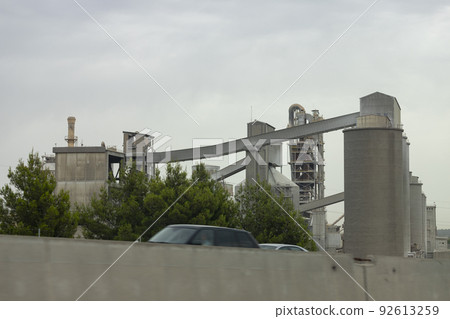 Factory. Cement factory seen from the outside on a cloudy day, in Spain. Europe. Horizontal photography. 92613259