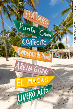 07.24.2022. Dominican Republic Bavaro Punta cana provinces La Altagracia. Wooden pillar with signposts directions 92613375