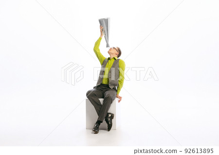 Portrait of stylish young man in a suit shouting in megaphone isolated over white studio background. Big sales Portrait of stylish young man in a suit shouting in megaphone isolated over white studio background. Big sales 92613895