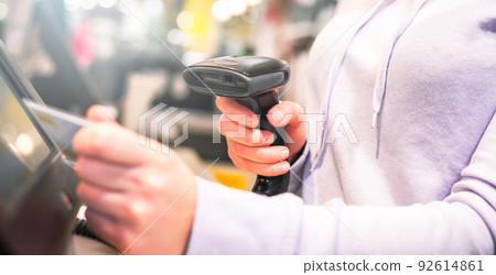 Young woman hands scanning, entering discount, sale on receipt, touch screen cash register, market, shop, finance concept Young woman hands scanning, entering discount, sale on receipt, touch screen cash register, market, shop, finance concept 92614861