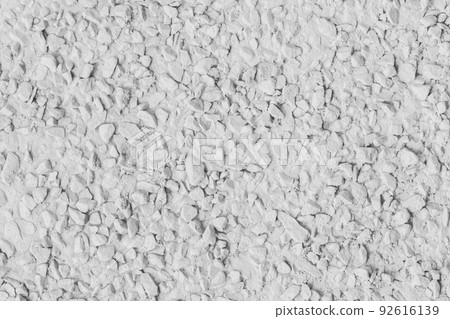 White paint on stone pebble surface solid texture wall background 92616139