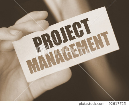 PROJECT MANAGEMENT words on card businessman holds. Bbusiness concept 92617725