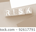 Risk Word On wooden cubes with pink wallet besides on pink background. Business startup risk and crisis management concept 92617791