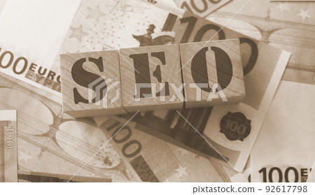 SEO - wooden blocks with letters, search engine optimization SEO concept, top view on 100 euro banknotes background 92617798